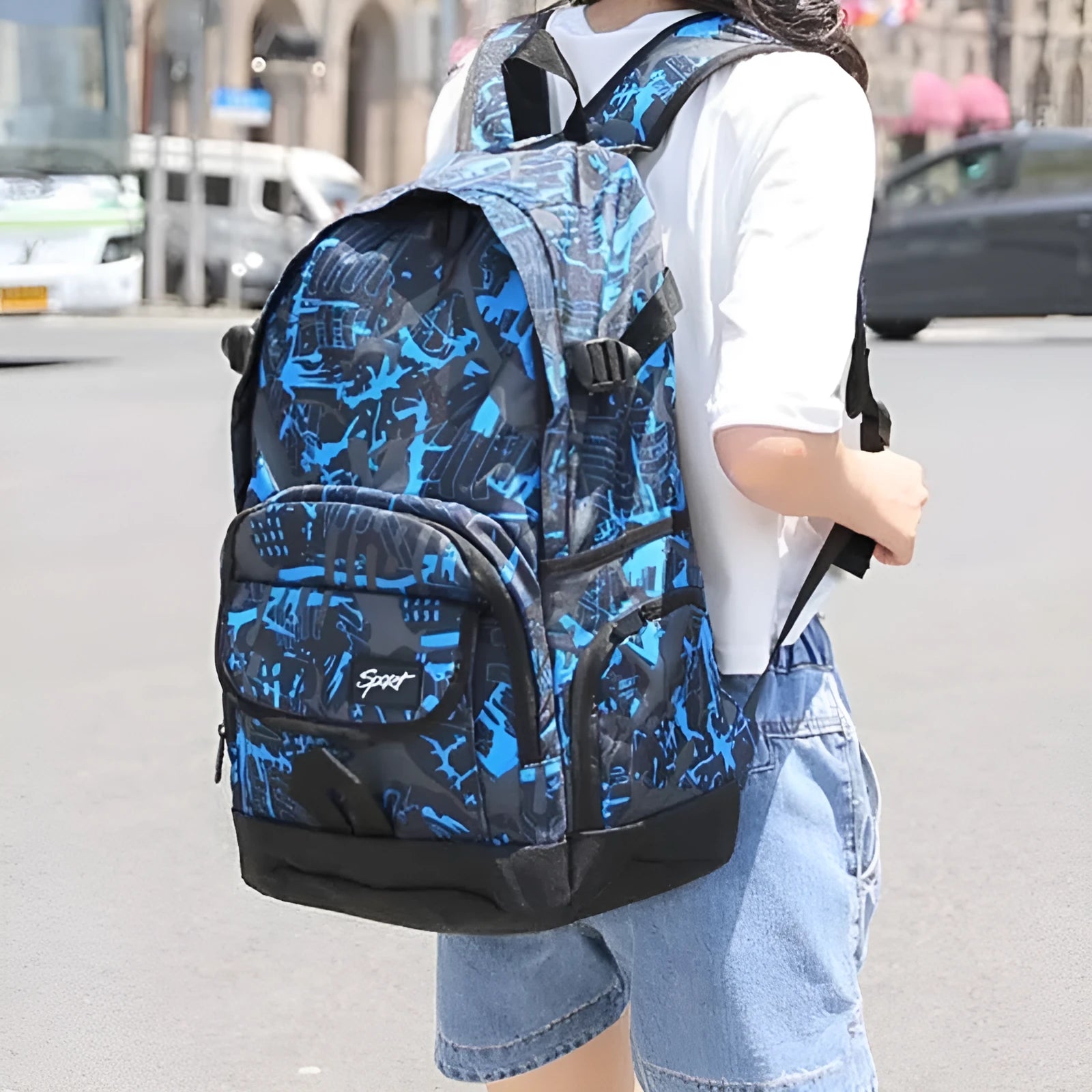 Classic blue nylon backpack with large main compartment shown open.