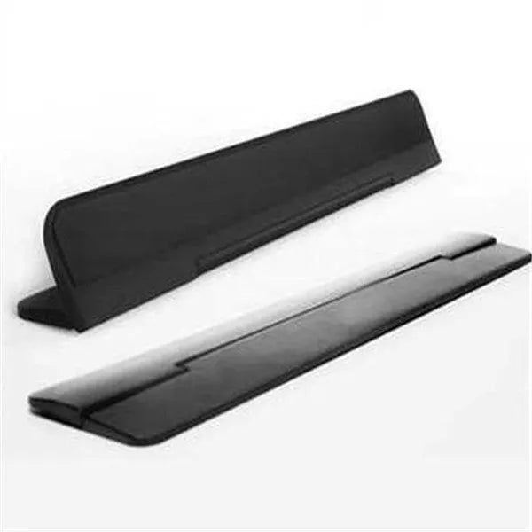 Folding notebook cooling bracket in black on a desk showing raised position for laptop heat dissipation