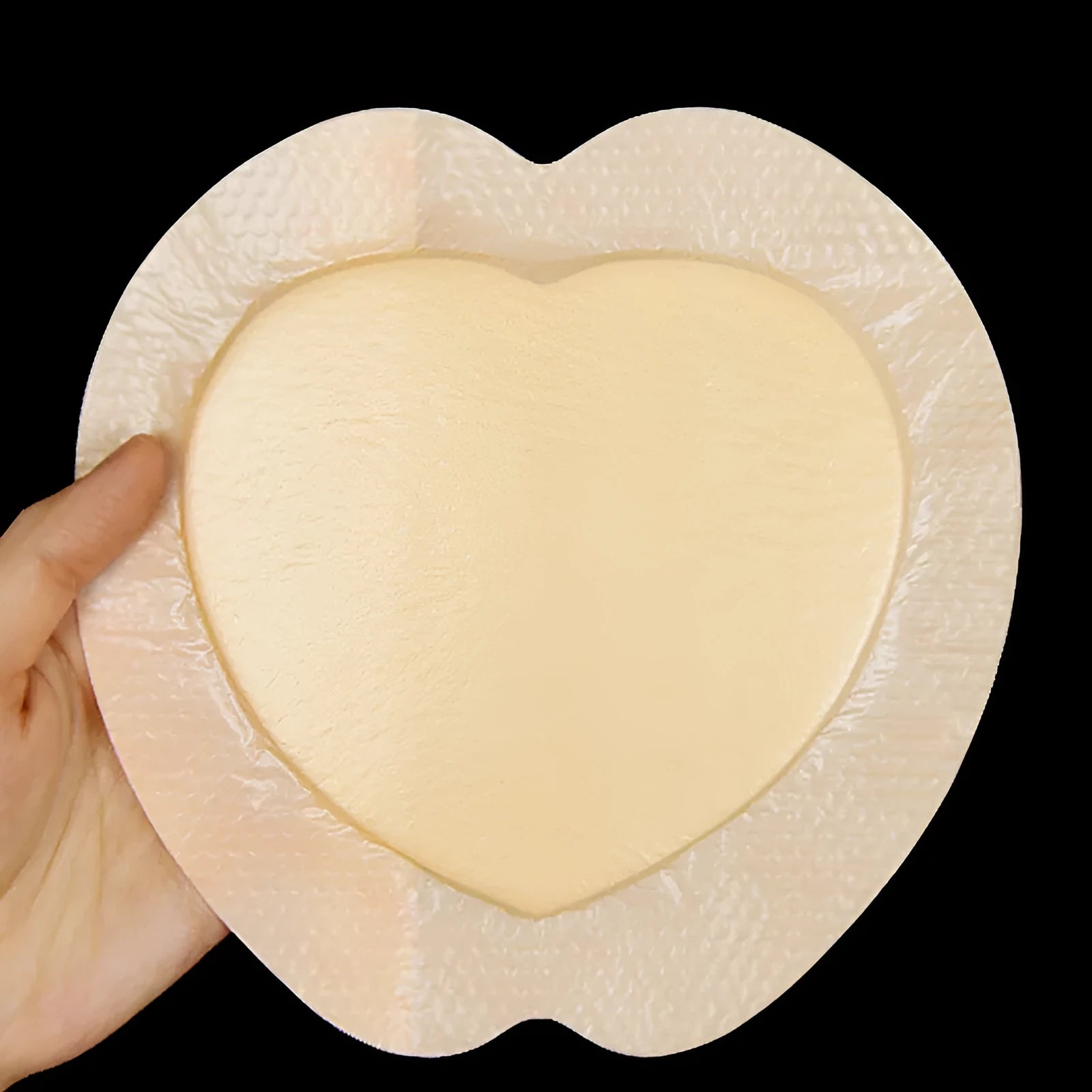 Large skin-coloured silicone foam pressure ulcer dressing sticker on white background