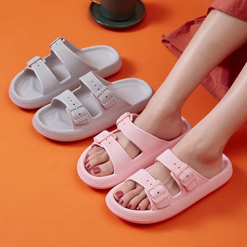 Women's beige platform slippers with buckle fastening and round toe on a flat surface