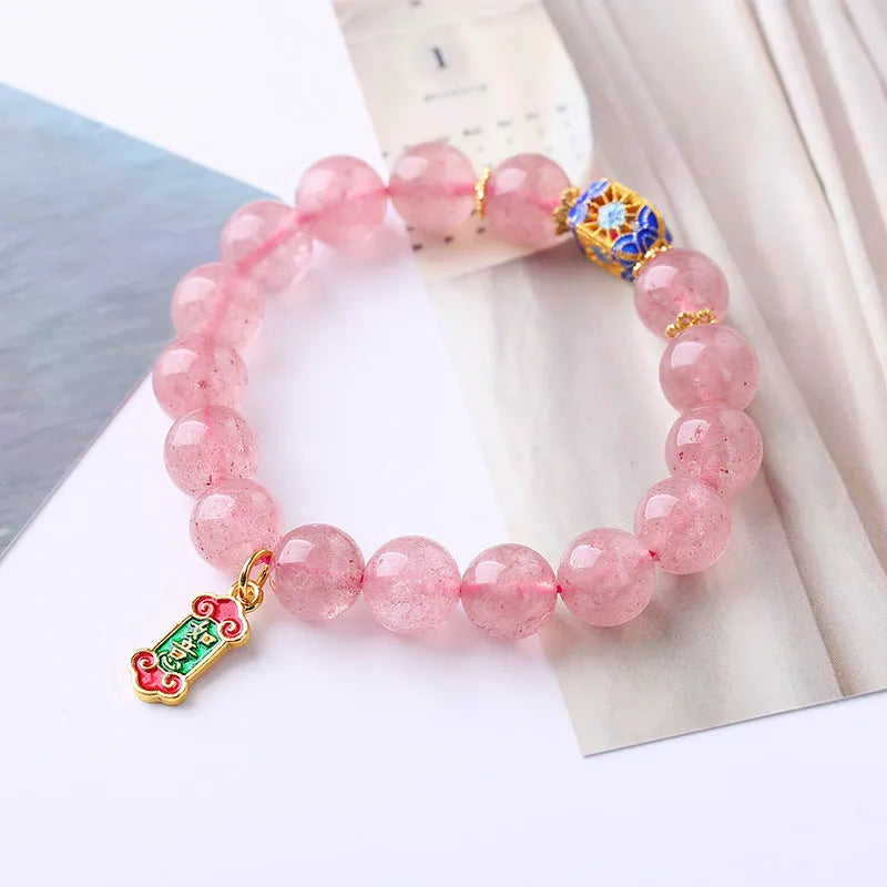Pink strawberry quartz crystal bracelet with Ruyi charm and hand-woven design for women.
