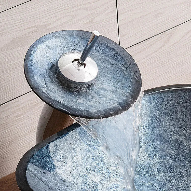 Blue grey tempered glass bathroom table basin with simple design on a vanity.
