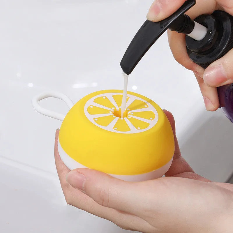 Yellow silicone pet bath brush with massage bristles and a combed grooming section on a single handle.
