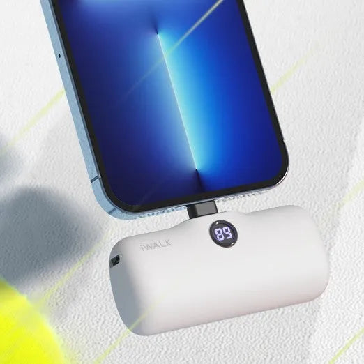 Compact white lipstick-shaped power bank showing screen display and charging port.