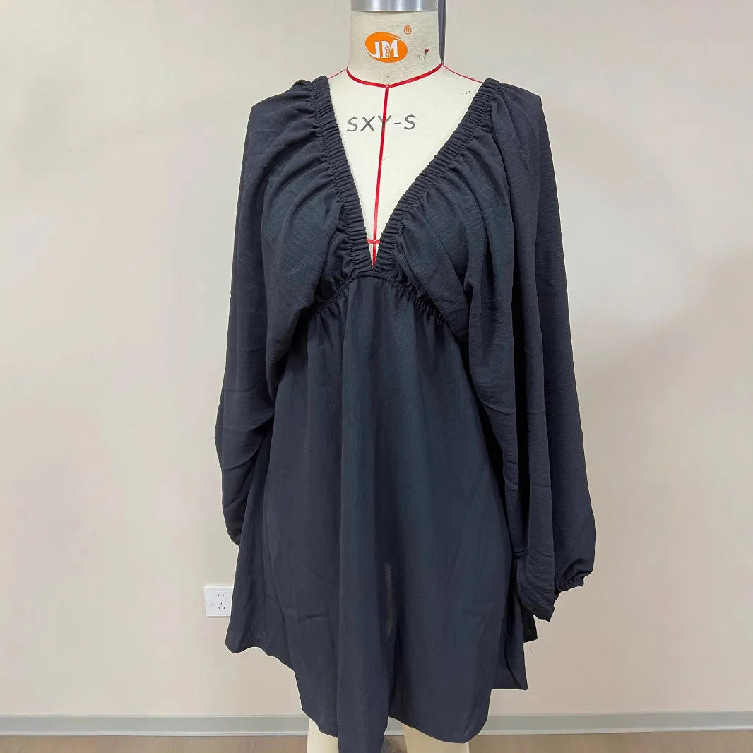 Women's v-neck long sleeve dress with puff sleeves and a flounced swing skirt in polyester fabric.