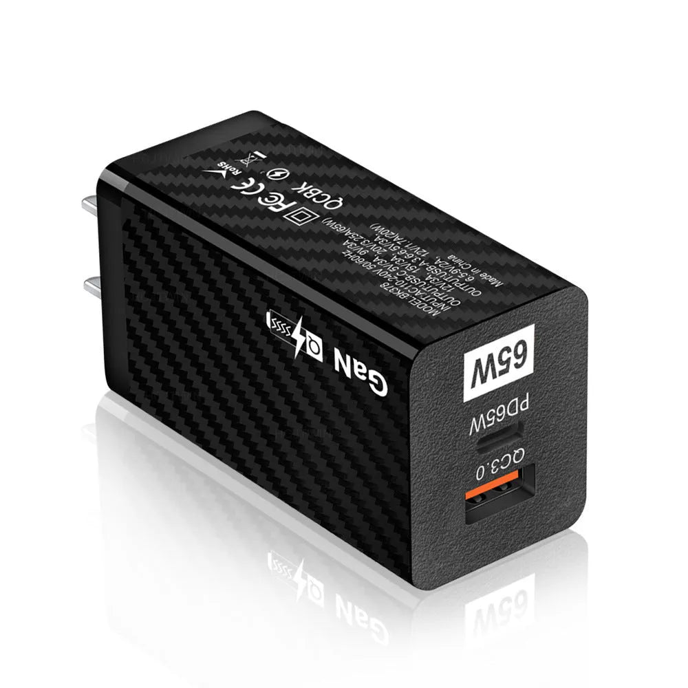 White and black 65W GaN USB-C laptop travel charger with UK, US, and EU plug options
