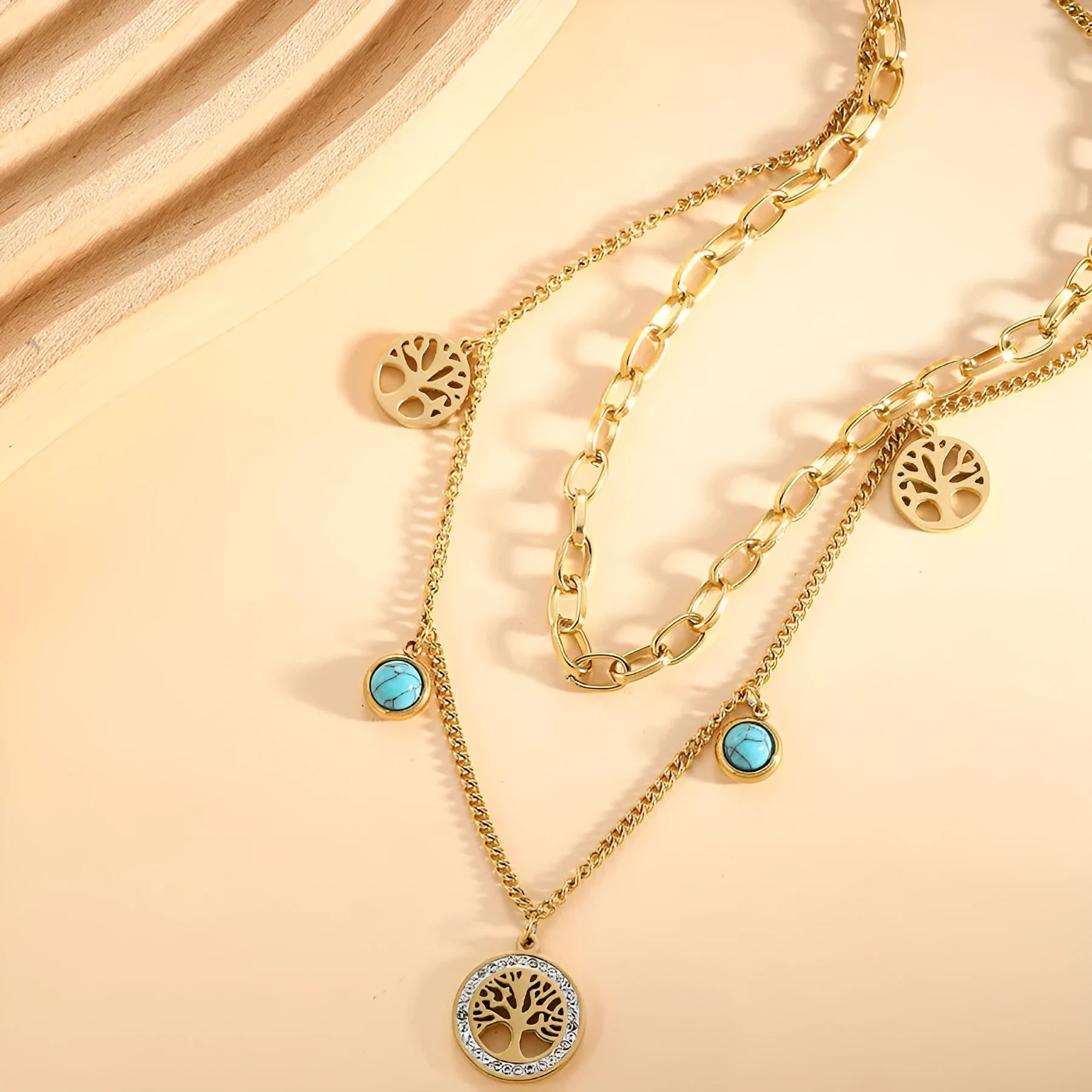 Gold titanium steel multi-layer box chain necklace with turquoise accent on model