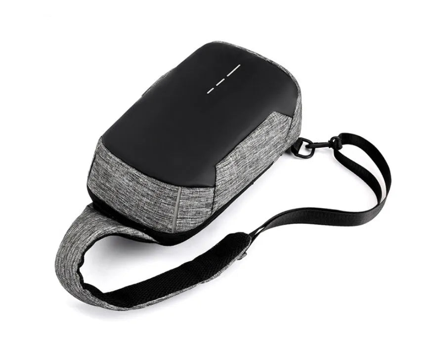 Small dark blue oxford cloth chest bag with a zipper and adjustable strap, showing internal phone pocket.