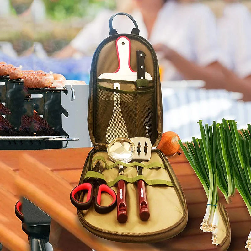 8-piece stainless steel camp kitchen cooking utensil set in black Oxford storage bag on green background