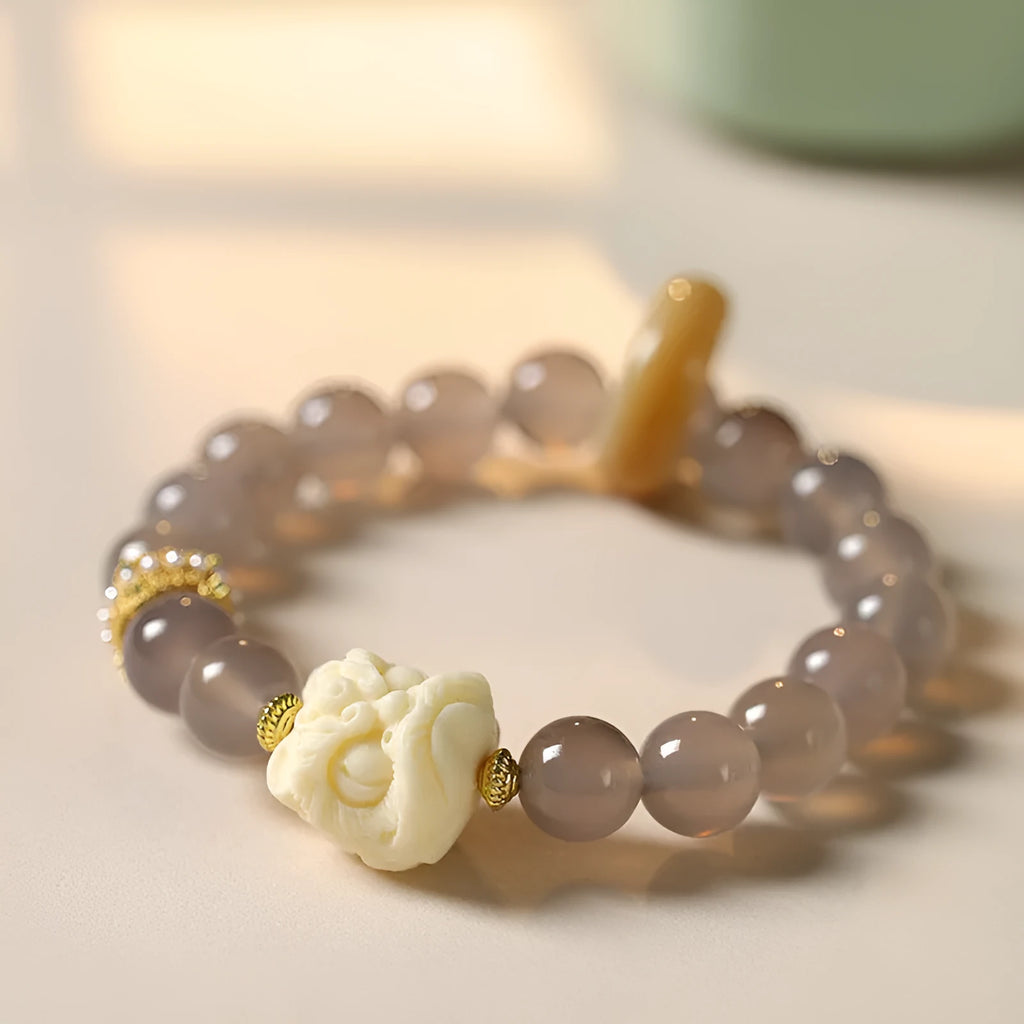 Hand-woven bracelet with 10mm round grey agate and mellite beads on a single strand.