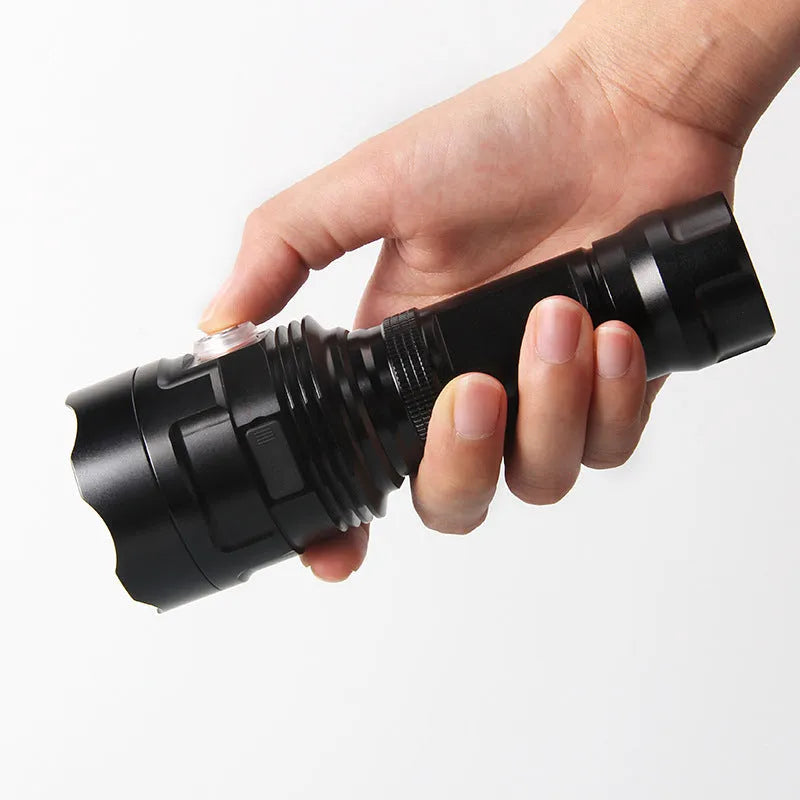 Black aluminium alloy tactical LED flashlight with a large 55mm head, shown with USB cable and yellow box.