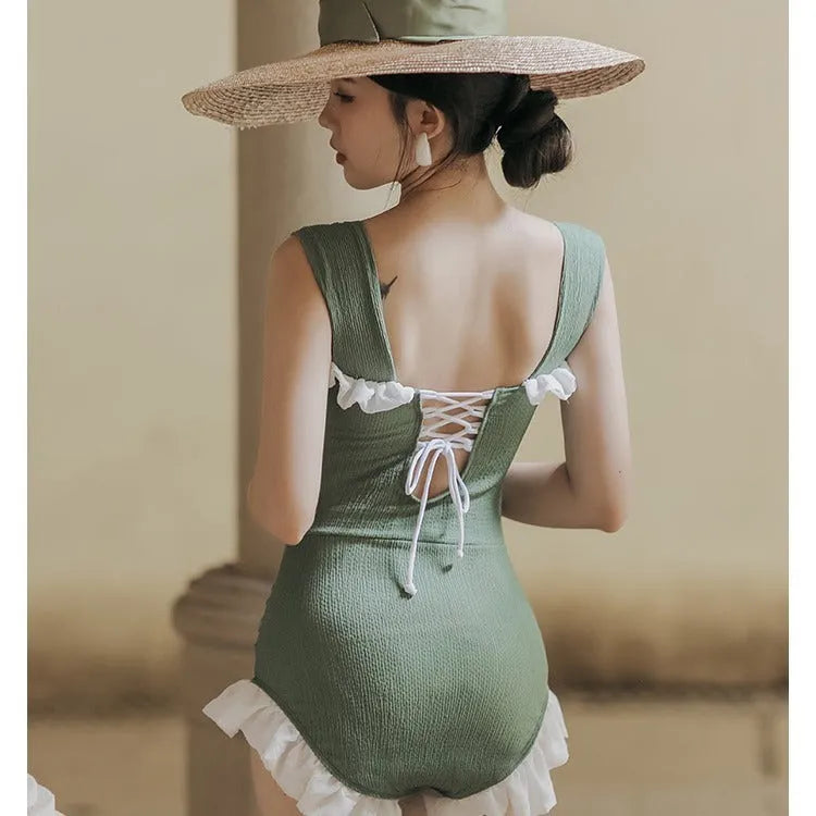 Women's black high-waisted one-piece triangle swimsuit, Korean style, on a mannequin.