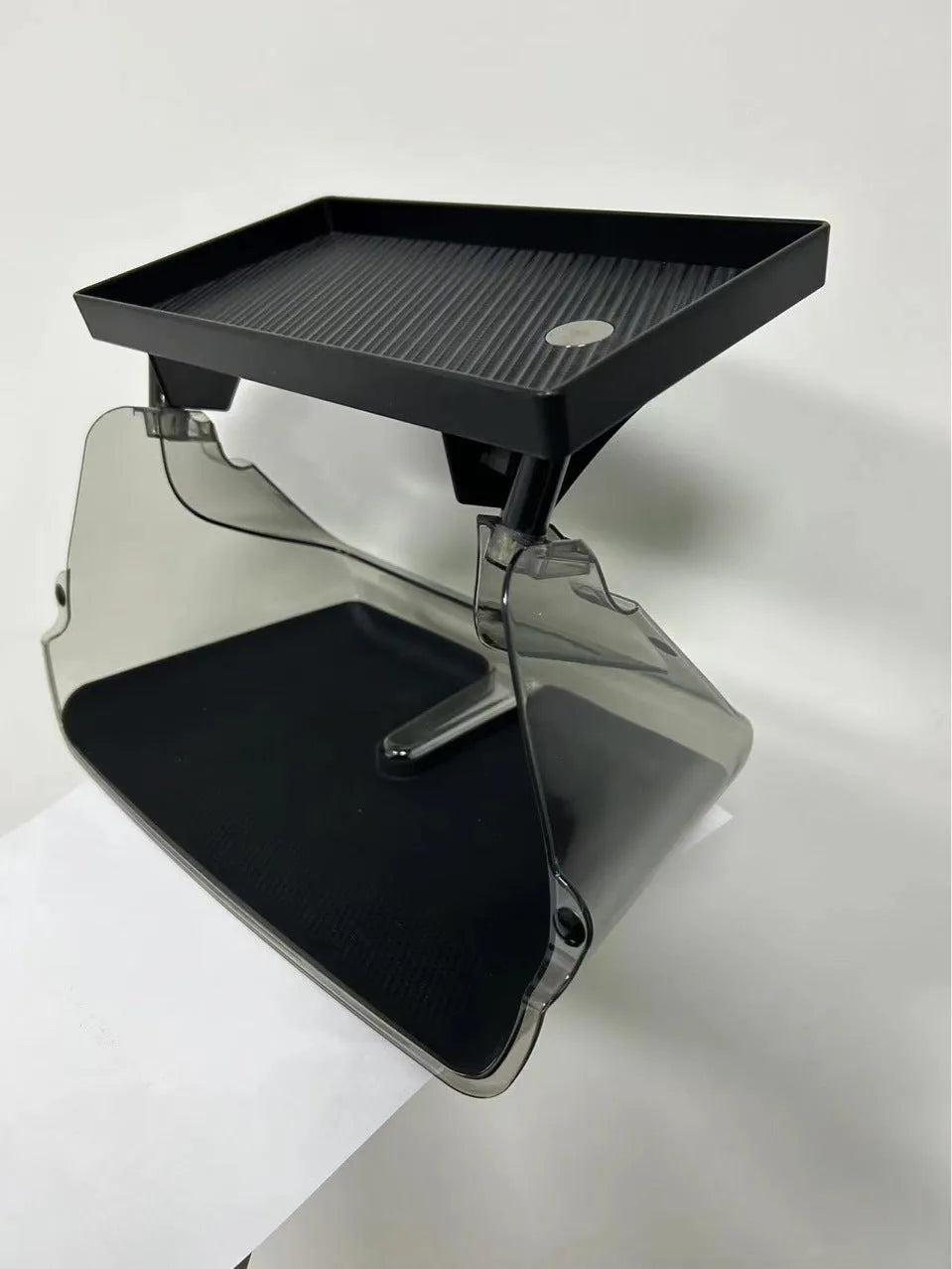 Black ABS plastic storage box fitted under the touchscreen of a Tesla Model Y interior.