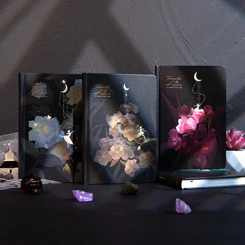 A5 notebook with luminous cover and silver foiling, open to show pages with colour illustrations.