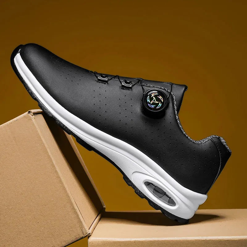 Pair of black low-top mesh tennis shoes with cross shoulder straps and white laces.