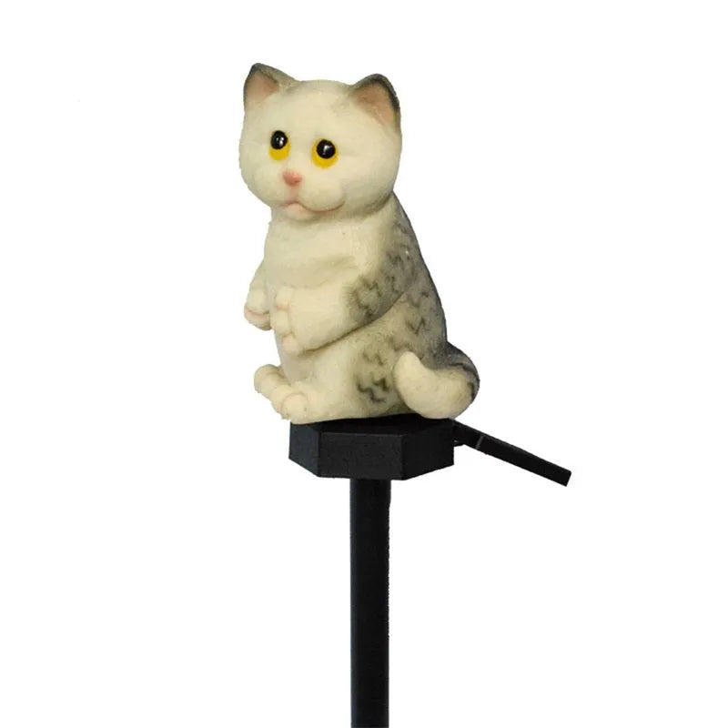 Brown cat-shaped resin solar light standing in a garden