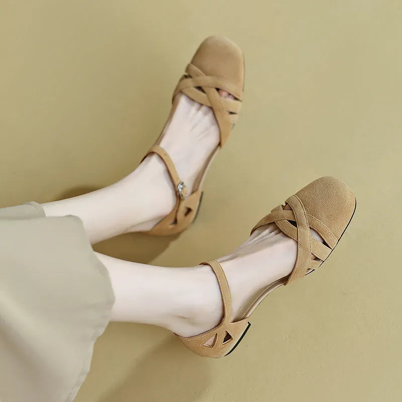 Apricot and green retro Roman sandals with a buckle strap and round toe on a rubber sole.