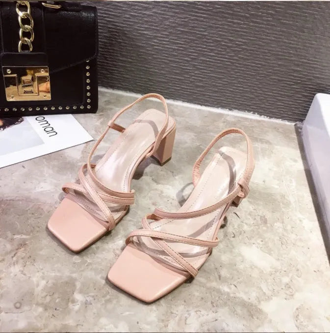 Women's white thick heel sandals with a super high heel and sleeve-style strap.
