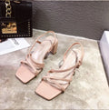 Women's white thick heel sandals with a super high heel and sleeve-style strap.