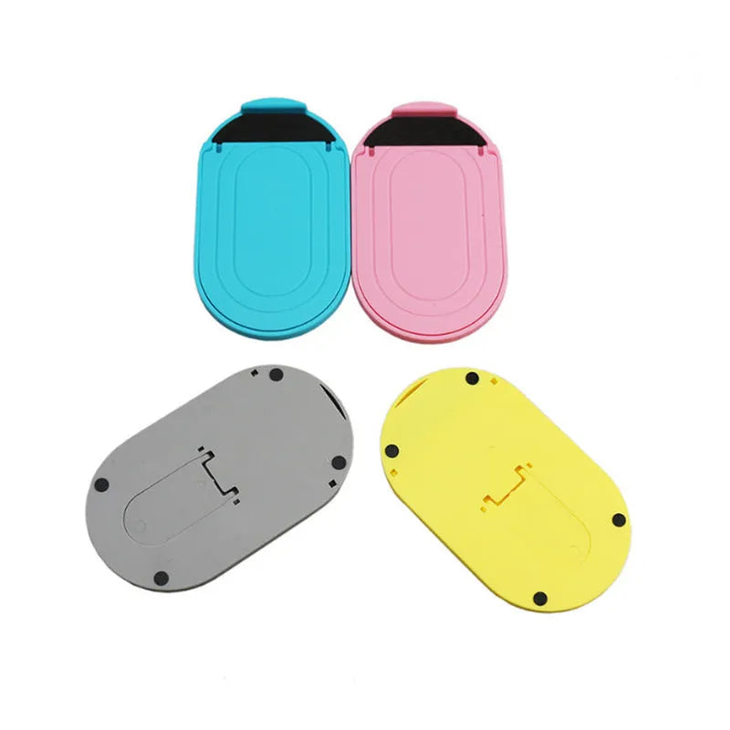 A foldable plastic mobile phone stand in a lazy bracket shape, shown in a selection of colours.