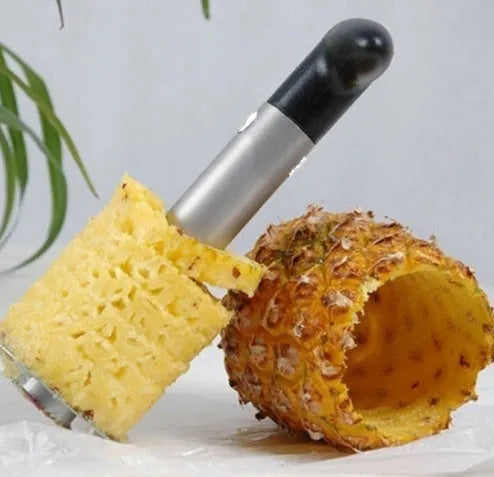 Stainless steel pineapple corer slicer with coloured ABS handle on a kitchen counter