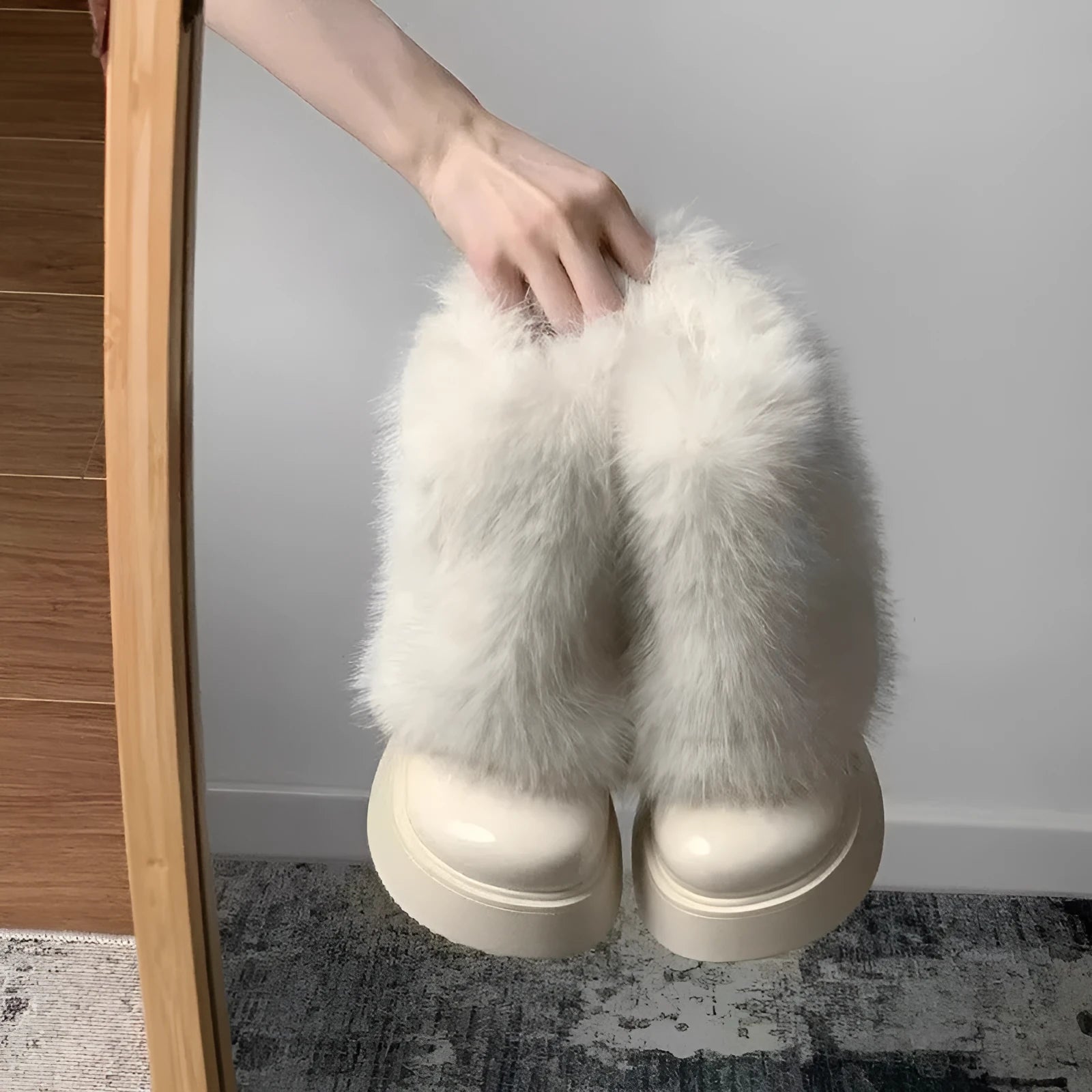 Women's black fleece-lined snow boot with a round toe and mid rubber heel on a white background.