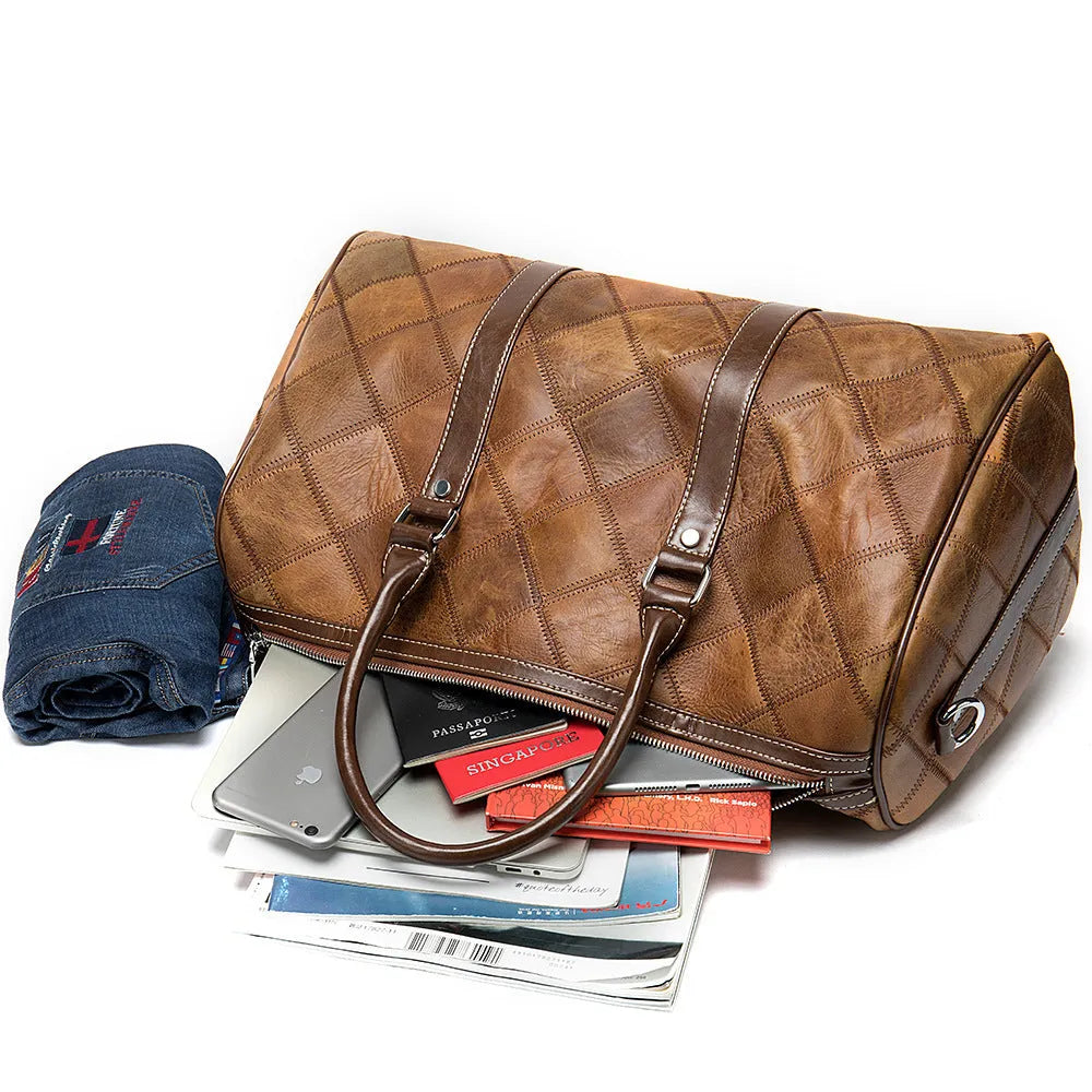 Vintage brown leather men's duffel bag with a single shoulder strap shown open to reveal internal organiser pockets.