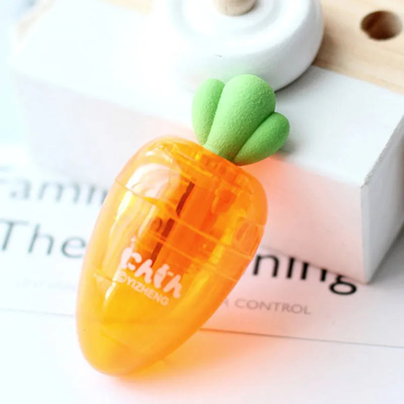 Carrot-shaped orange plastic pencil sharpener with green top, showing compact size next to pencil