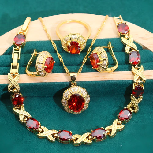 18k gold plated jewellery set showing ring, earrings, bracelet, and necklace with coloured cubic zirconia stones.