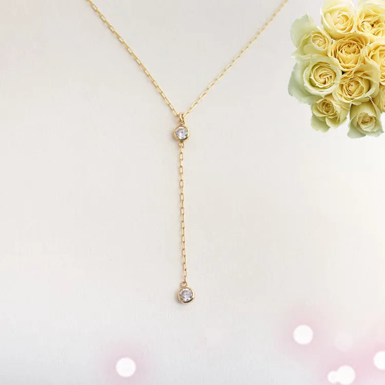 Gold colour alloy geometric pendant necklace with snake bone chain on display