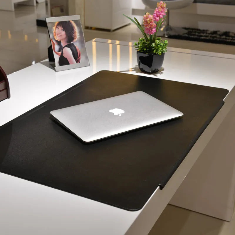 Large PVC computer desk mat 700x450mm in black with non-slip backing on a desk