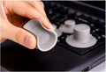 Grey plastic laptop cooling pad stand with four non-slip pads on a desk.