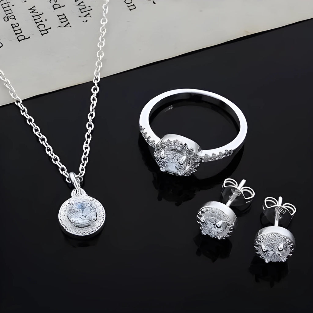 Zircon jewellery suit with inlaid apple ring and necklace silver tone on white background