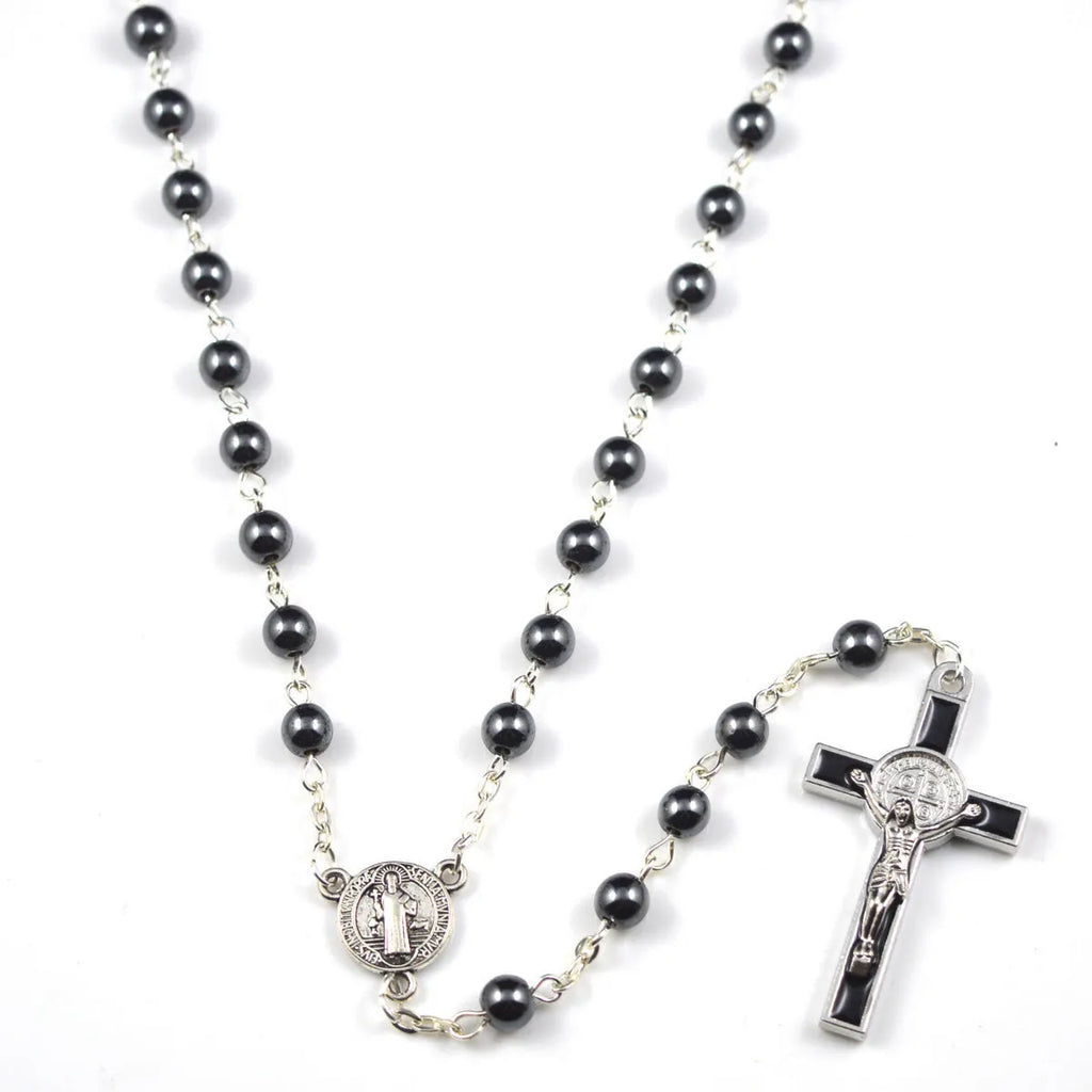 Black hematite rosary necklace with zinc alloy cross and triangle on dark background