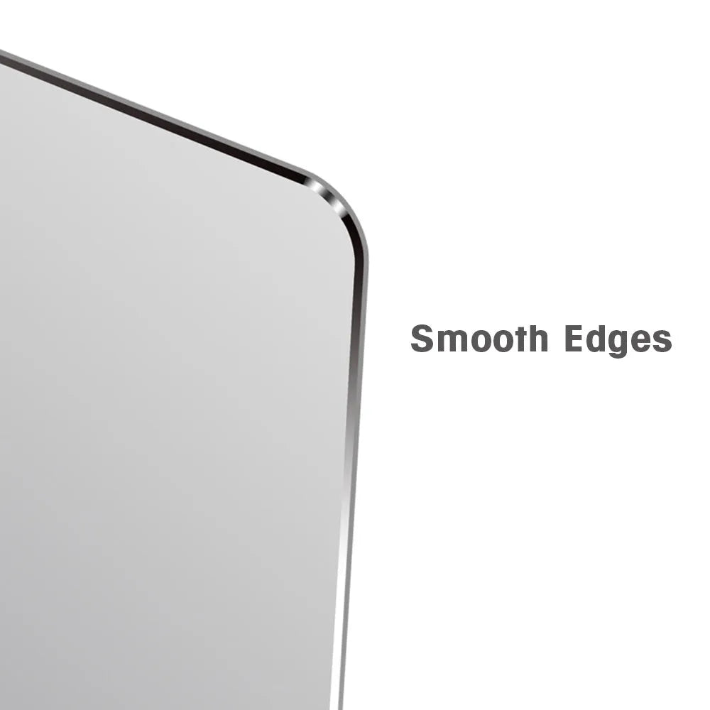 Black aluminium alloy double-sided mouse pad on a desk with a computer mouse on top