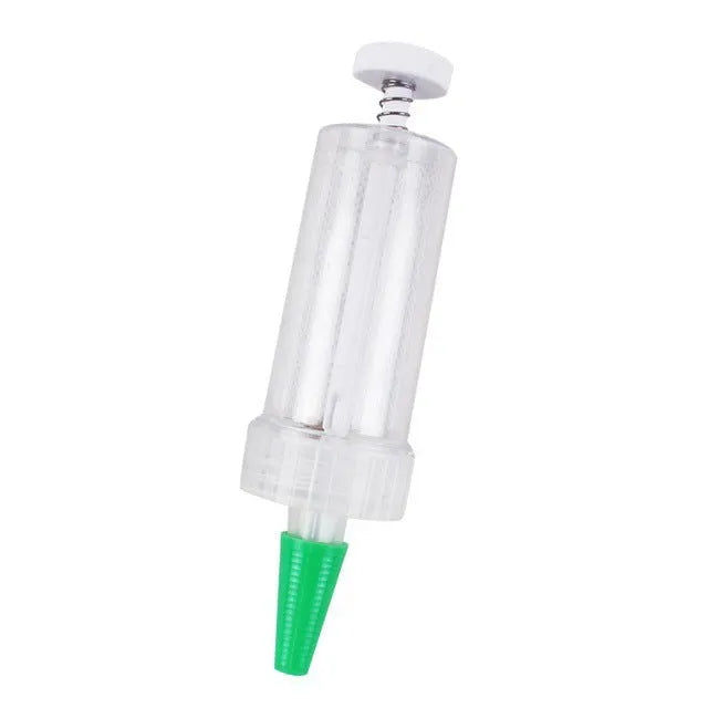 A white plastic mini seeder tool measuring 12cm long, used for planting seeds in pots and trays.