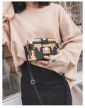 Hard black PU women's shoulder handbag with flap, hasp closure, and decorative rivets.
