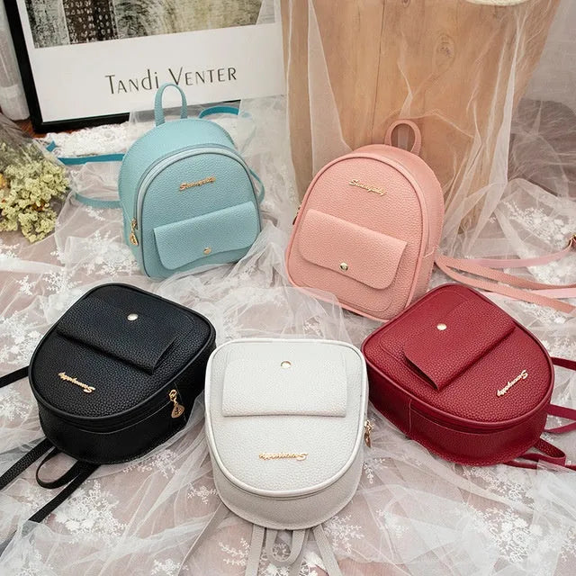 Compact black PU leather women's small backpack with a slim profile and zipper closure.