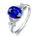 Women's butterfly ring with heart-shaped design in copper and rose gold plating, showing blue and red colour options