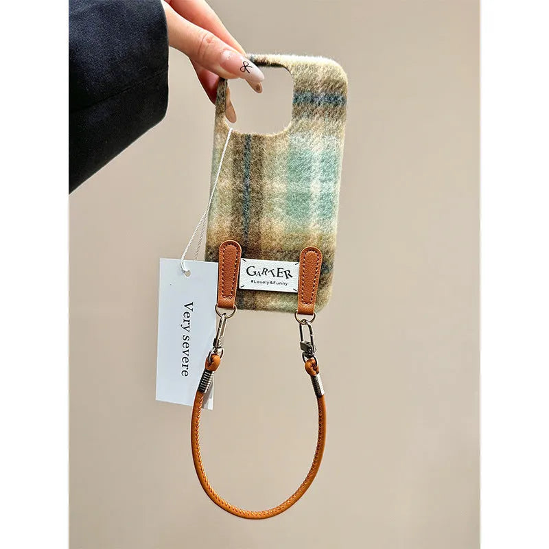 Flannel plaid phone case with wristband in black green and red checkered, compatible with iPhone models.