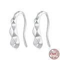 Close-up of S925 sterling silver rhombus earrings with diamond plaid pattern on a neutral background