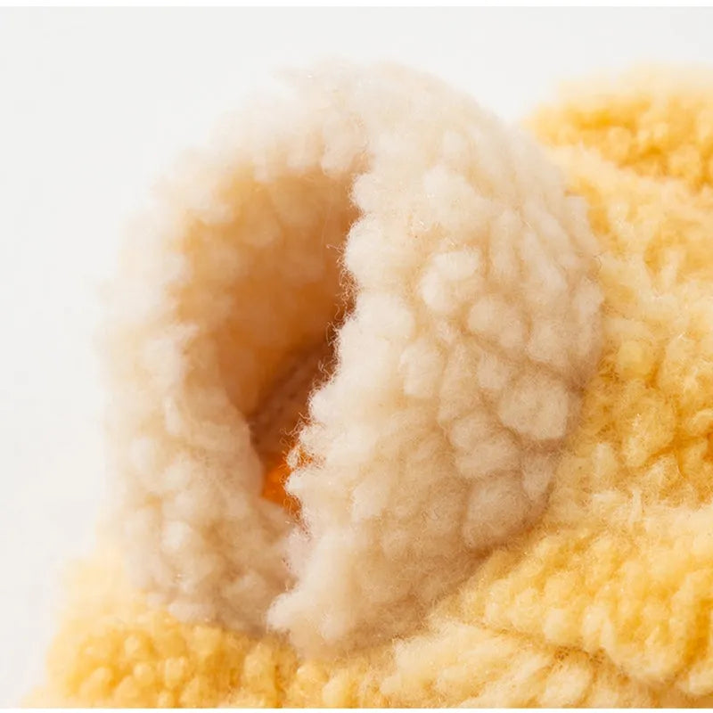 Yellow striped lambskin fleece dog clothing with bear patch and leash ring on a small dog