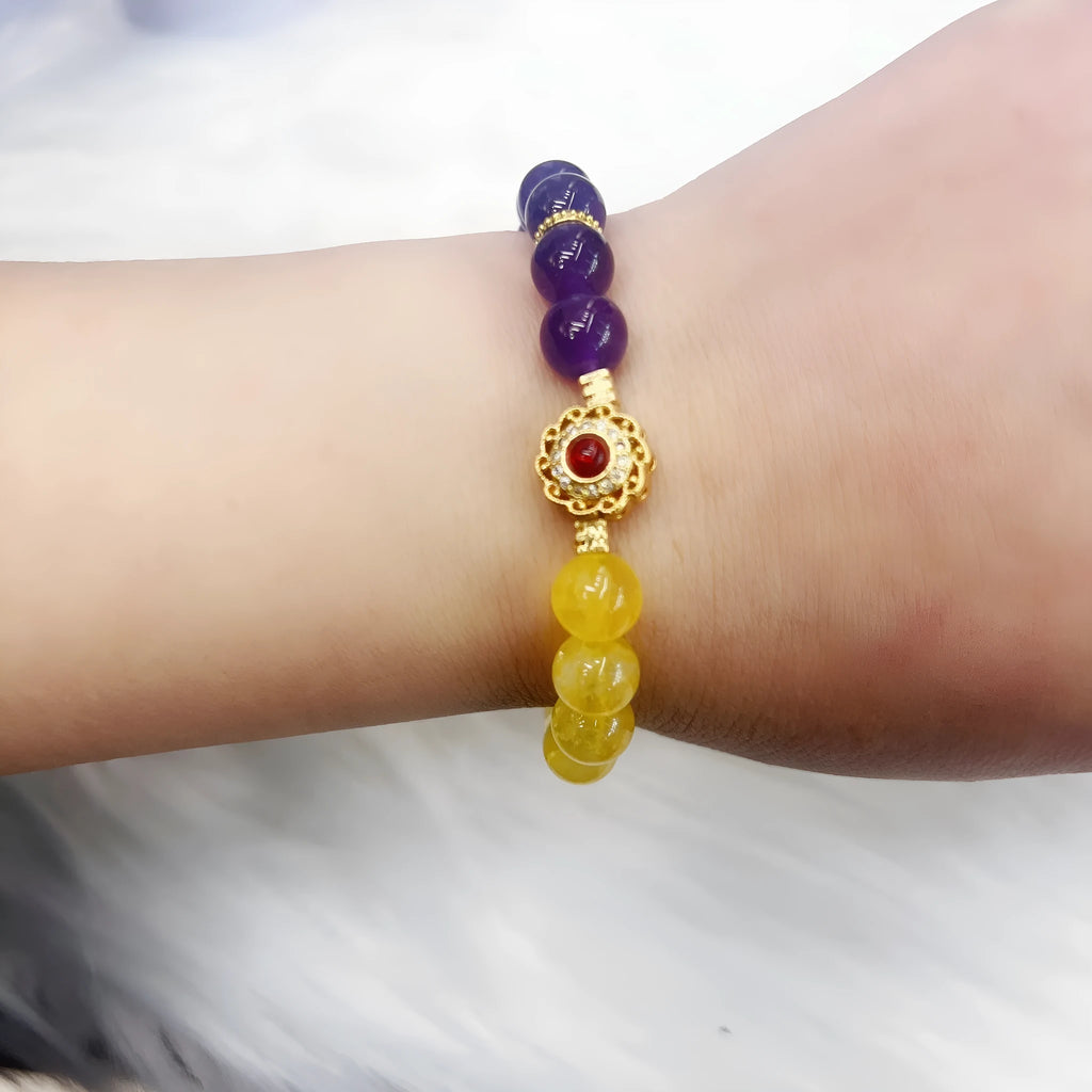 Handmade women's bracelet with yellow and purple amethyst crystals on wrist