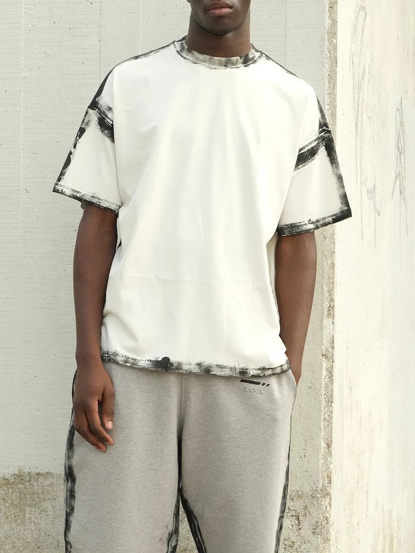 White casual short sleeve polyester top with draped design and printed elements on regular fit model