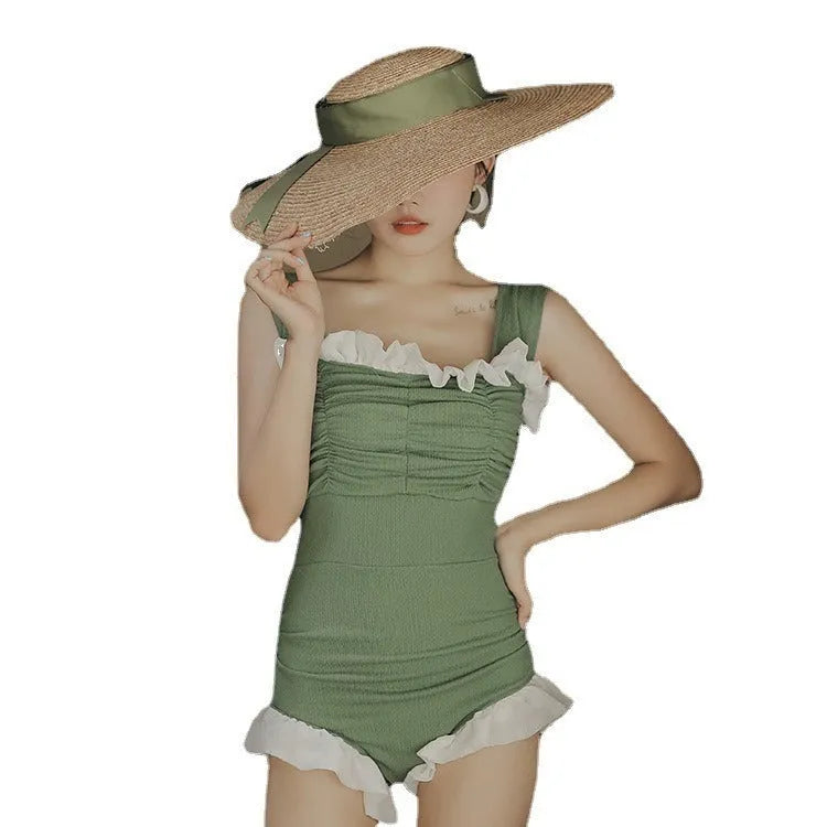 Women's black high-waisted one-piece triangle swimsuit, Korean style, on a mannequin.