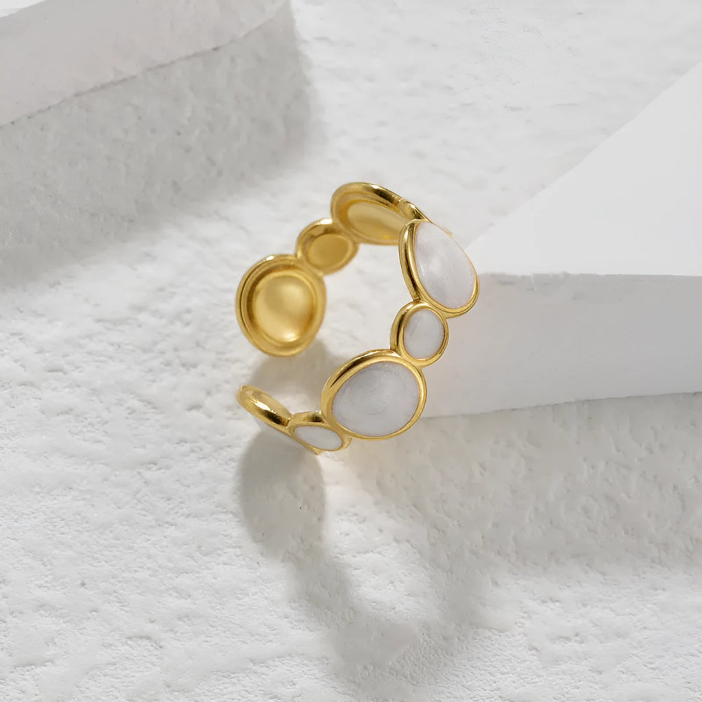 A geometric stainless steel ring for women with an adjustable opening and electroplated finish.