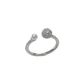 Gold and silver coloured open-end ring with round zircon on a geometric band.