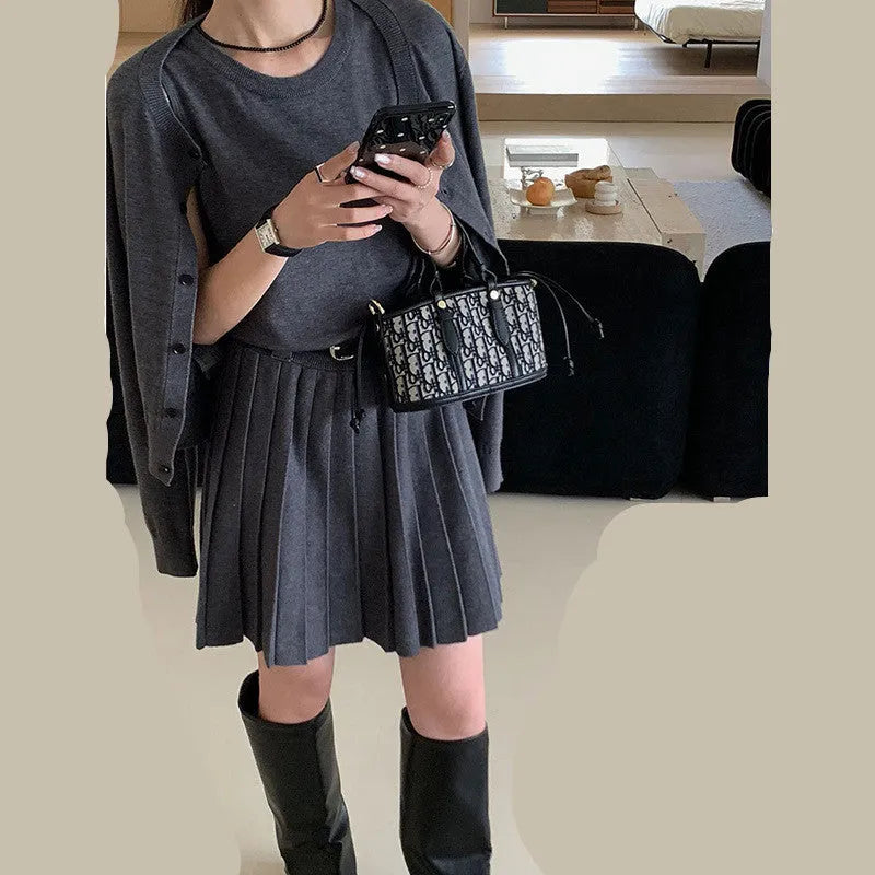 Grey Art Retro style women's knitted vest skirt and long-sleeved cardigan two-piece set with a 3D pattern.