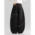Black straight-leg denim trousers laid flat, showing zip fly and mid-waist design.