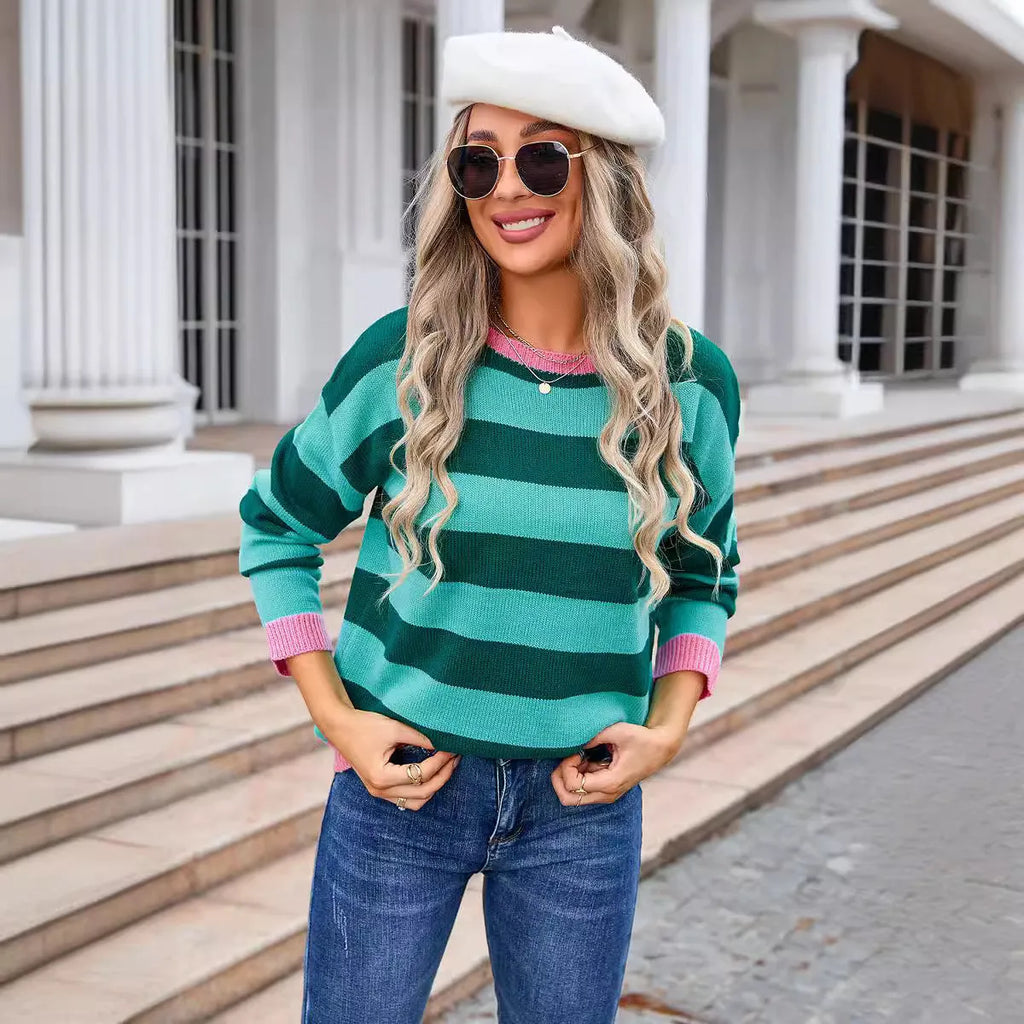Women's loose blue striped acrylic knit sweater with long sleeves on a hanger.